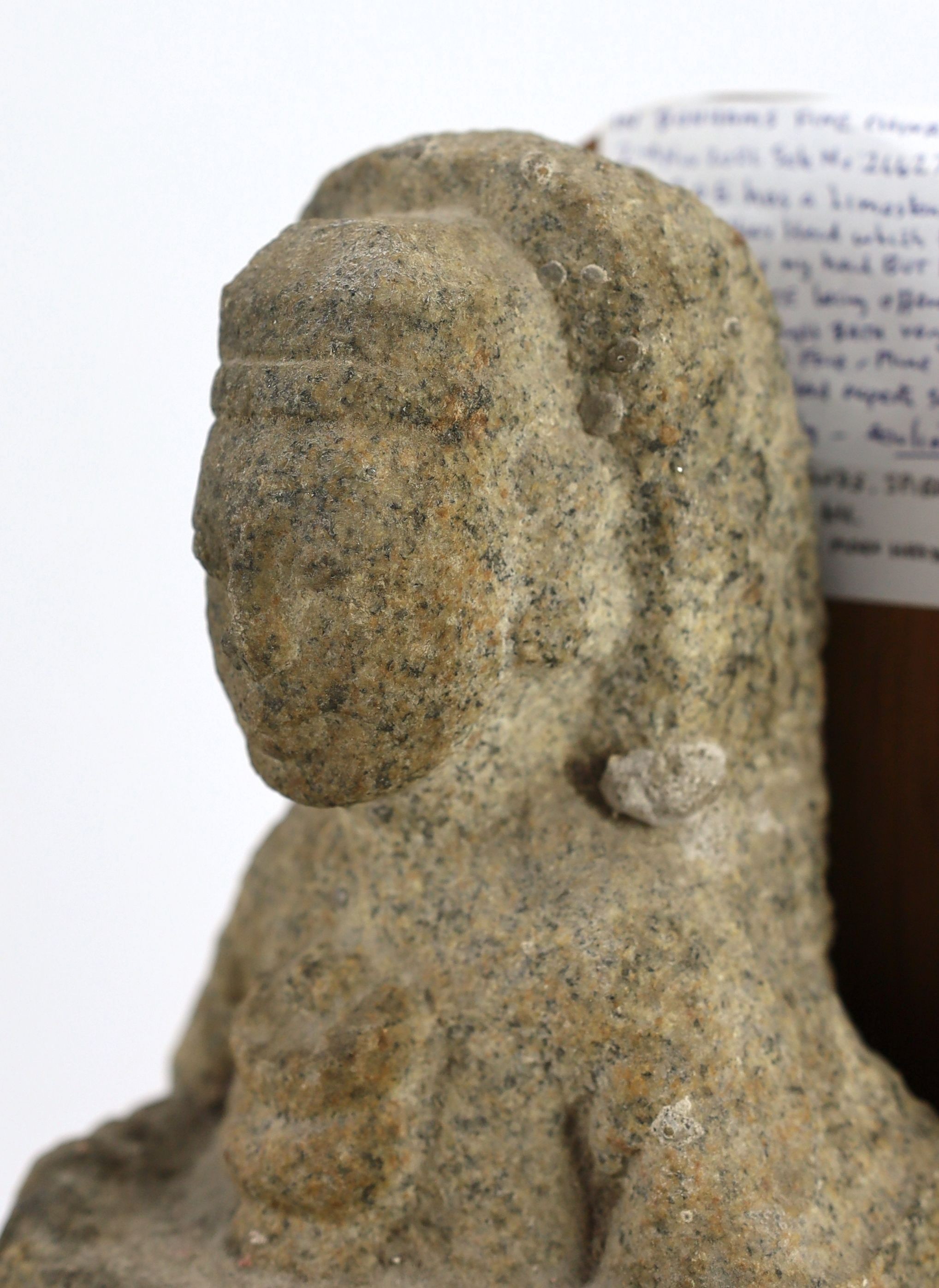 A Chinese granite fragment of a Buddhist offering figure, probably Northern Wei dynasty, 22.5cm, later stand